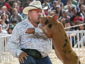 Buffalo Bill gets a kiss from his hog dog at the PNE.