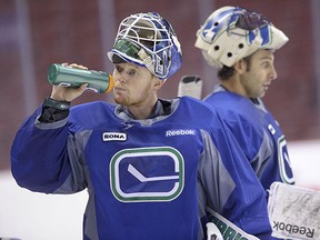Cory Schneider grabs a drink at practice during the 2012-13 season, his last one playing in tandem with Roberto Luongo.