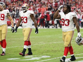 GLENDALE, AZ - SEPTEMBER 21:  (L-R)  Aaron Lynch #59,  Demarcus Dobbs #83 and Ian Williams #93 of the San Francisco 49ers walk off the field late in the fourth quarter of the NFL game against the Arizona Cardinals at the University of Phoenix Stadium on September 21, 2014 in Glendale, Arizona. The Cardinals defeated the 49ers 23-14. (Photo by Christian Petersen/Getty Images)