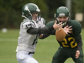 Torr Dhalgren (left) of the Nanaimo District Islanders, and Jackson Washington of the Argyle Pipers battle on Friday. Pipers won the AA contest 41-6 in North Vancouver. (Richard Lam, PNG)