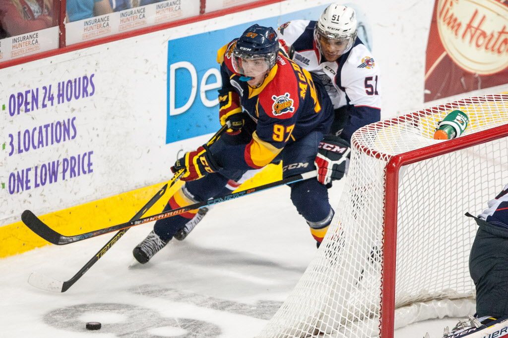 WINDSOR, ON - SEPTEMBER 26: Connor McDavid #97 of the Erie Otters moves the puck against Jalen Chatfield #51 of the Windsor Spitfires on September 26, 2014 at the WFCU Centre in Windsor, Ontario, Canada. (Photo by Dennis Pajot/Getty Images) ORG XMIT: 513276757