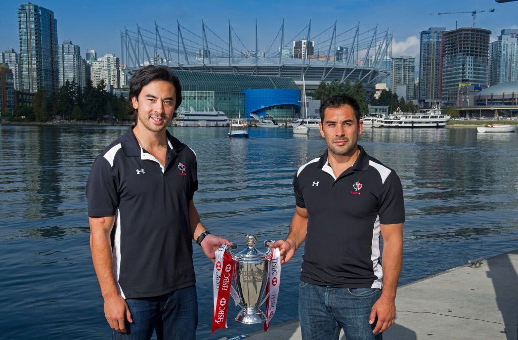 Nathan Hirayama (left) and Phil Mack of the Rugby Canada sevens team pose with the HSBC Sevens World Series trophy. (Photo by Rich Lam/Getty Images)