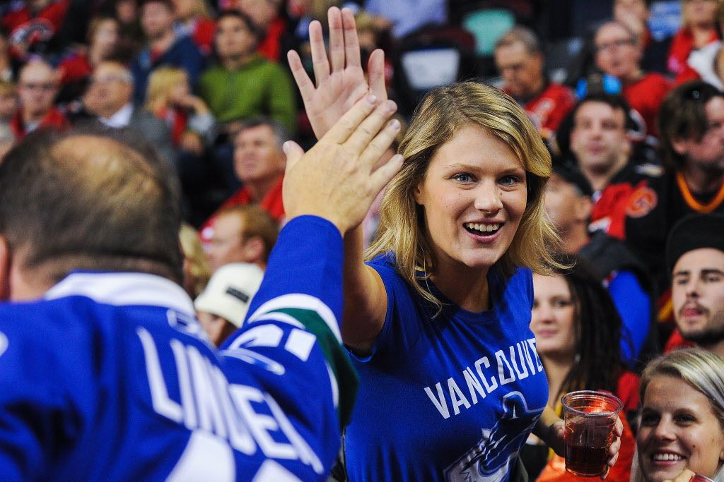 CALGARY, AB - OCTOBER 8: Fans of the Vancouver Canucks reacts after a goal against the Calgary Flames during an NHL game at Scotiabank Saddledome on October 8, 2014 in Calgary, Alberta, Canada. (Photo by Derek Leung/Getty Images)