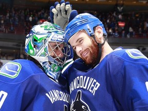 VANCOUVER, BC - OCTOBER 28:  Zack Kassian #9 of the Vancouver Canucks congratulates Ryan Miller #30 who recorded his 300th NHL victory, a win over the Carolina Hurricanes in their NHL game at Rogers Arena October 28, 2014 in Vancouver, British Columbia, Canada.  Vancouver won 4-1. (Photo by Jeff Vinnick/NHLI via Getty Images)