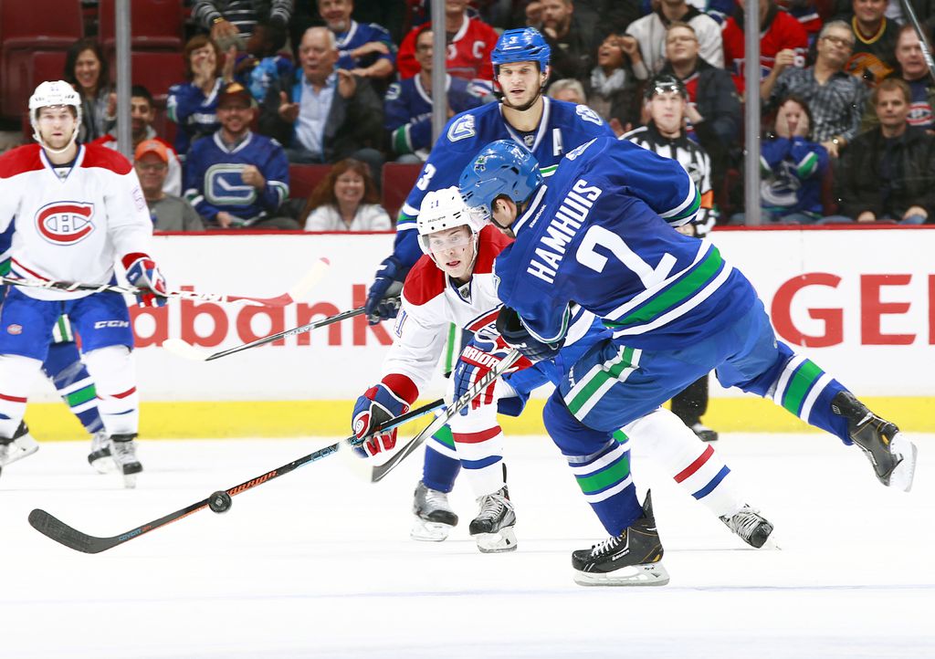 VANCOUVER, BC - OCTOBER 30: Brendan Gallagher #11 of the Montreal Canadiens reaches to deflect a shot by Dan Hamhuis #2 of the Vancouver Canucks during their NHL game at Rogers Arena October 30, 2014 in Vancouver, British Columbia, Canada. (Photo by Jeff Vinnick/NHLI via Getty Images)