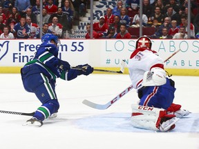 VANCOUVER, BC - OCTOBER 30:  Daniel Sedin #22 of the Vancouver Canucks scores the overtime winning goal against Eddie Lack #31 of the Vancouver Canucks in their NHL game at Rogers Arena October 30, 2014 in Vancouver, British Columbia, Canada. Vancouver won 3-2 in overtime. (Photo by Jeff Vinnick/NHLI via Getty Images)