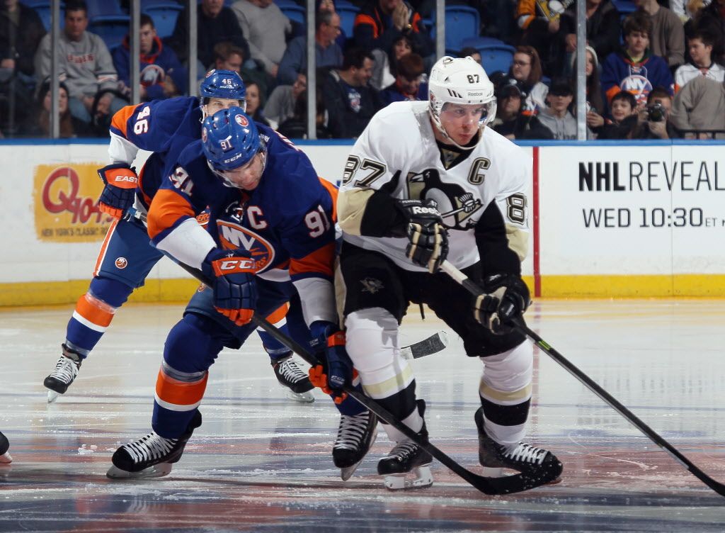 UNIONDALE, NY - JANUARY 23:  John Tavares #91 of the New York Islanders skates against Sidney Crosby #87 of the Pittsburgh Penguins during the first period at Nassau Veterans Memorial Coliseum on January 23, 2014 in Uniondale, New York. Both players will play for Team Canada at the upcoming Olympic games in Sochi, Russia.  (Photo by Bruce Bennett/Getty Images) ORG XMIT: 181113572