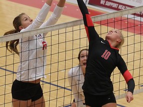 SFU's Amanda Renkema (left) battles for a ball at the net with Nortwest Nazarene University's setter Michelle Terpstra in GNAC women's volleyball match Thursday at SFU. (Ron Hole, SFU athletics)