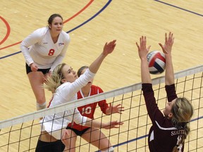 Simon Fraser University right side Mackenzie Dunham attempts a kill against visiting Seattle Pacific  middle blocker Madi Cavell in SFU's five-set win Thursday at the  West Gym. (Ron Hole, SFU athletics)