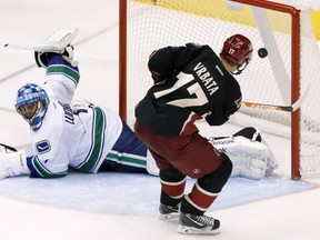 Phoenix Coyotes' Radim Vrbata (17), of the Czech Republic, scores against Vancouver Canucks' Roberto Luongo during the shootout in an NHL hockey game on Tuesday, Nov. 5, 2013, in Glendale, Ariz. The Coyotes defeated the Canucks 3-2 in a shootout. (AP Photo/Ross D. Franklin) ORG XMIT: PNJ108