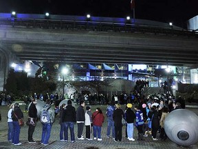 Canucks fans wait outside Rogers Arena for an open scrimmage in January, 2013. On Thursday, they were receiving the airport security treatment before entering the building.