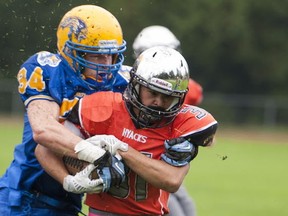 Handsworth's Matt Anderson (left) attempts to slow New Westmintser's Julian Ramirez during AAA action Friday on the Shore. Ramirez rushed for 132 yards in a 42-14 victory. (Richard Lam, PNG photo)