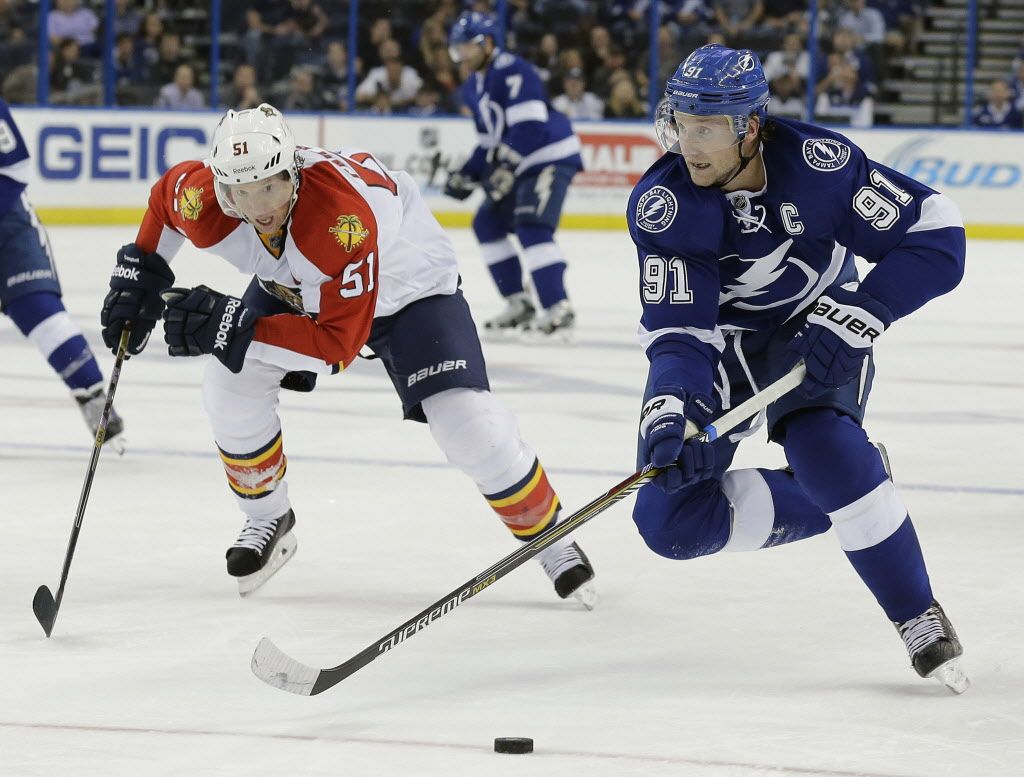Tampa Bay Lightning center Steven Stamkos (91) gets ahead of Florida Panthers defenseman Brian Campbell (51) during the second period of an NHL preseason hockey game Saturday, Oct. 4, 2014, in Tampa, Fla. (AP Photo/Chris O'Meara)  ORG XMIT: TPA106