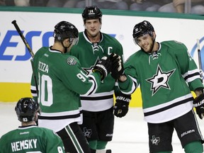 Dallas Stars' Ales Hemsky (83) of Czech Republic, Jason Spezza (90) and Jamie Benn (14) congratulate Tyler Seguin (91) on his goal in the third period of a preseason NHL hockey game against the Florida Panthers, Monday, Sept. 29, 2014, in Dallas. Seguin scored three goals and the Stars rallied to beat the Panthers 5-4. (AP Photo/Tony Gutierrez) 10022014xSPORTS