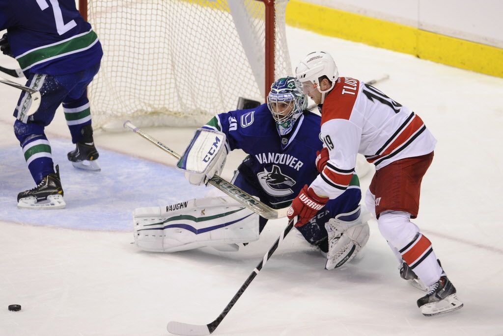 Vancouver B.C. October 28, 2014. Battling for control Vancouver Canucks Ryan MILLER 30, is busy on  the night  against the Carolina Hurricanes in Rogers Arena in Vancouver on Oct. 28, 2014.   Mark van Manen/PNG Staff  Photographer   see    Vancouver Sun /Province Sports stories /Features and WEB [PNG Merlin Archive]