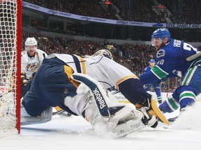 Pekka Rinne #35 of the Nashville Predators makes a save on Chris Higgins #20 of the Vancouver Canucks during their NHL game at Rogers Arena November 2, 2014 in Vancouver, British Columbia, Canada. (Photo by Jeff Vinnick/NHLI via Getty Images)