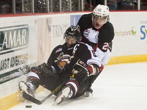 Vancouver Giants captain Dalton Sward gets knocked down by Prince George Cougar Tate Olson on Nov. 22. That was the last home game for Troy Ward as Giants coach. (Richard Lam/Province)