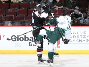 Giants defenceman Arvin Atwal knocks down Silvertips defenceman Jordan Wharrie during Everett's 5-1 win Friday at the Pacific Coliseum (Vancouver Giants photo.)