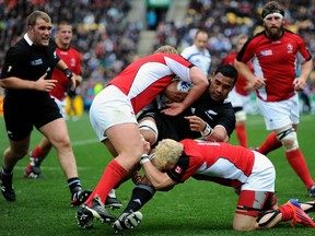 WELLINGTON, NEW ZEALAND - OCTOBER 02:  Jerome Kaino of the All Blacks is wrapped up by the Canada defence during the IRB Rugby World Cup Pool A match between New Zealand and Canada at Wellington Regional Stadium on October 2, 2011 in Wellington, New Zealand.  (Photo by Mike Hewitt/Getty Images)