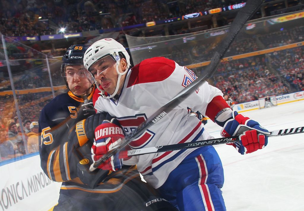 BUFFALO, NY - NOVEMBER 05: Rasmus Ristolainen #55 of the Buffalo Sabres and Alexei Emelin #74 of the Montreal Canadiens check each other into the corner glass on November 5, 2014 at the First Niagara Center in Buffalo, New York.  Montreal won 2-1. (Photo by Bill Wippert/NHLI via Getty Images)