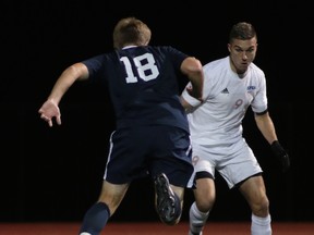 SFU's Jovan Blagojevic (right) goes one-on-one with WWU's Kurtis Pederson during GNAN regular season finale for both teams Saturday night at Fox Field. (Photo -- David Zuskind/SFU Athletics)