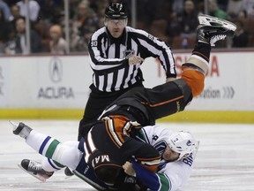 Anaheim Ducks left wing Patrick Maroon, top, and Vancouver Canucks defenseman Kevin Bieksa brawl during the first period of an NHL hockey game in Anaheim, Calif., Sunday, Nov. 9, 2014. (AP Photo/Chris Carlson)