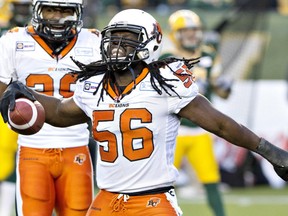 B.C. Lions Solomon Elimimian (56) celebrate the interception against the Edmonton Eskimos during first half CFL action in Edmonton, Alta., on Saturday November 1, 2014. THE CANADIAN PRESS/Jason Franson.