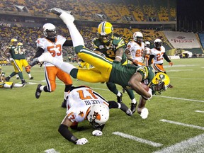 B.C. Lions T.J. Lee (17) colides with Edmonton Eskimos Adarius Bowman (4) as Fred Stamps (2) and Ryan King (53) give chase during second half CFL action in Edmonton, Alta., on Saturday November 1, 2014. THE CANADIAN PRESS/Jason Franson