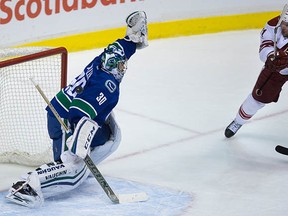 Martin Hanzal tips the puck past Vancouver goalie Ryan Miller for his second goal. Was that stick a little high?