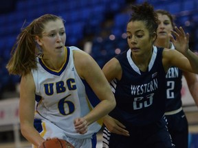 Kris Young (left) of the UBC Thunderbirds scored 17 points Saturday, but none of them came easy against guard Marcel Pounds and the rest of the Western Washington Vikings. The Bellingham school handed UBC its first loss in eight preseason games, taking a 68-62 decision at War Gym.