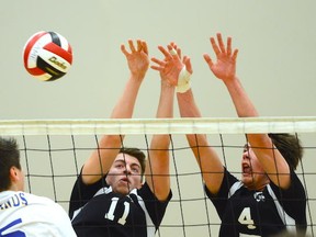 Kohl Linder (11) and Spencer Kingzett (4) of Penticton’s Princesss Margaret Mustangs share a block against Vancouver Island champion Woodland Eagles of Nanaimo during their opening match at the B.C. Senior boys Double A volleyball championships Wednesday at the Langley Events Centre. After surviving a bus crash Tuesday, the Mustangs arrived just in time for a match they would go on to win 2-1 (15-25, 28-18, 15-12).