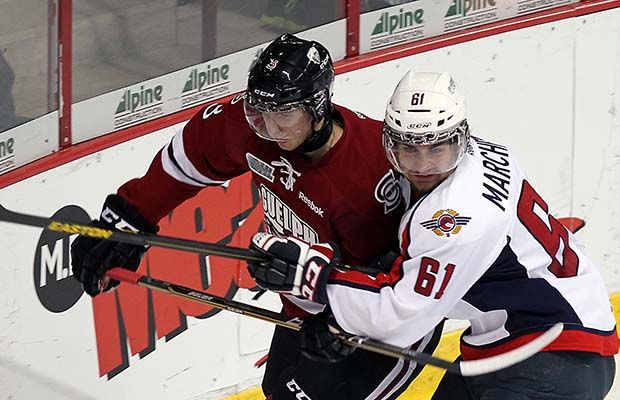 Andrey Pedan (left) battles with Windsor Spitfires Chris Marchese during his Guelph Storm days in 2012.