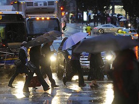 Vancouver B.C. November 3, 2014.  The Dark days at here--commuters dash across Burrard street (at Georgia Street) in the pouring rain late Monday after in Vancouver on  November 3, 2014.   Mark van Manen/PNG Staff  Photographer   see  Cheryl Chan Province News Vancouver Sun News stories /and WEB