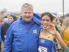 UBC's golden girl Maria Bernard with outgoing head coach Marek Zadrzejek holds the ceremonial silver shell casing from the starter's pistol, a sweet prize after winning an NAIA title Saturday in the US heartland. (Wilson Wong, UBC athletics)