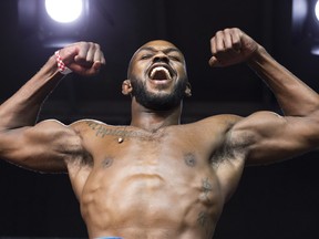 Jon Jones flexes during the weigh in for UFC 165 in Toronto, Friday September 20, 2013. THE CANADIAN PRESS/Mark Blinch ORG XMIT: MDB203