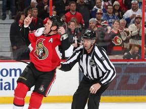OTTAWA, ON - DECEMBER 7: Linesman Brian Mach #78 steers Chris Neil #25 of the Ottawa Senators to the penalty box as he tries to get the fans going following a fight in the second period against the Vancouver Canucks during an NHL game at Canadian Tire Centre on December 7, 2014 in Ottawa, Ontario, Canada.  (Photo by Jana Chytilova/Freestyle Photography/Getty Images)