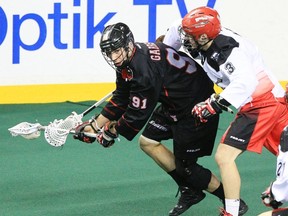 Tyler Garrison of the Stealth tries to play a little keep away with Dan MacRae of the Roughnecks in a game last season. Vancouver and Calgary have the first TSN game on Jan. 3. (Calgary Herald Files.)