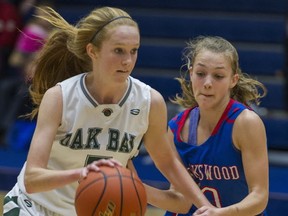 Oak Bay's Andrea Postka (left) fends with Brookswood's Julia Marshall during Tsumura Basketball Invitational final Sunday in Langley. (Ric Ernst, PNG)