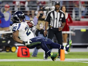 Seattle Seahawks running back Marshawn Lynch leaps into the end zone for a touchdown against the Arizona Cardinals during the second half of an NFL football game, Sunday, Dec. 21, 2014, in Glendale, Ariz. (AP Photo/Rick Scuteri)
