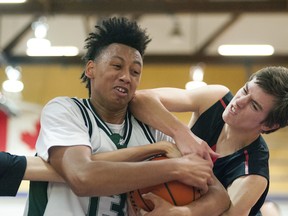 Oak Bay Bays’ centre Atlas St. Paul-Butler wasn’t about to give up the ball or the game to Port Coquitlam’s Terry Fox Ravens. The Victoria team beat the Ravens 101-93 in the championship final of the Vancouver College Emerald Tournament last Saturday and now sit at No. 2 in The Province’s Big 10 rankings. (Wilson Wong, UBC athletics)