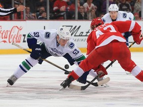 Bo Horvat's ability in the face-off circle, like here against Detroit's Darren Helm, is part of the reason why he's becoming a key player for the Canucks.  (Photo by Dave Reginek/NHLI via Getty Images)