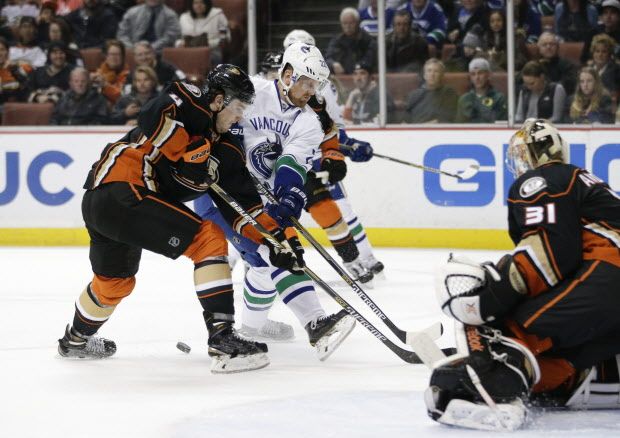 Anaheim Ducks' Cam Fowler, left, defends Vancouver Canucks' Daniel Sedin, of Sweden, during the first period of an NHL hockey game Sunday, Dec. 28, 2014, in Anaheim, Calif. (AP Photo/Jae C. Hong)