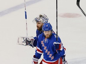 Derek Dorsett celebrates the New York Rangers' Game 4 victory over the L.A. Kings in last year's Stanley Cup Final with goalie Henrik Lundqvist while playing for the New York Rangers. He's now with the Canucks. (Paul Bereswill, Getty Images files)