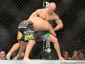 Dec 6, 2014; Las Vegas, NV, USA; Johnny Hendricks grinds Robbie Lawler into the fence at UFC 181. (photo credit Joe Camporeale-USA TODAY Sports)