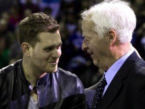 Canadian singer Michael Buble, left, and NHL Hockey Hall of Fame member Gordie Howe share a laugh after Buble sang "Happy Birthday" to him during an 85th birthday ceremony before the Vancouver Giants and Lethbridge Hurricanes WHL hockey game in Vancouver B.C., on Friday March 1, 2013. Howe turns 85 on March 31. THE CANADIAN PRESS/Darryl Dyck ORG XMIT: VCRD127