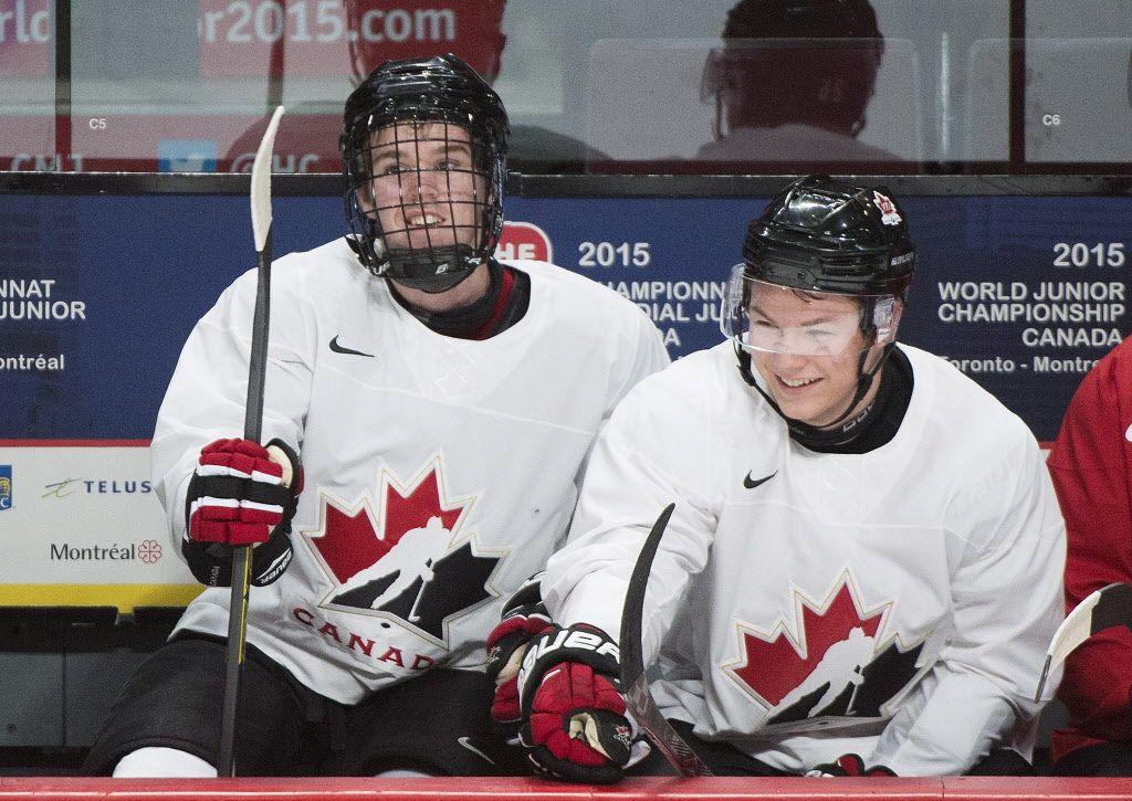 Team Canada players Connor McDavid, left, and Curtis Lazar chat during a practice session in Montreal, Wednesday, December 24, 2014. THE CANADIAN PRESS/Graham Hughes