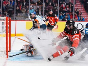 Canada's Connor McDavid showers Finnish goalie Juuse Saros with snow on Monday. McDavid will be joined by Canucks prospect Jake Virtanen today against the U.S.