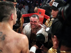 Mike Alvarado quit on his stool after three rounds of brutal punishment from Brandon Rios. Photo: Chris Farina / Top Rank