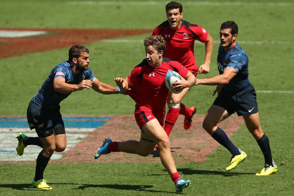 GOLD COAST, AUSTRALIA - OCTOBER 11:  Sean Duke of Canada is tackled during the 2014 Gold Coast Sevens Pool D match between Canada and Argentina at Cbus Super Stadium on October 11, 2014 in Gold Coast, Australia.  (Photo by Chris Hyde/Getty Images)