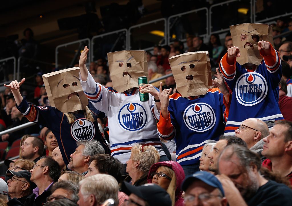 GLENDALE, AZ - DECEMBER 16:  Fans of the Edmonton Oilers wearing bags on their heads react during the NHL game against the Arizona Coyotes at Gila River Arena on December 16, 2014 in Glendale, Arizona. The Coyotes defeated the Oilers 2-1 in an overtime shootout.  (Photo by Christian Petersen/Getty Images)